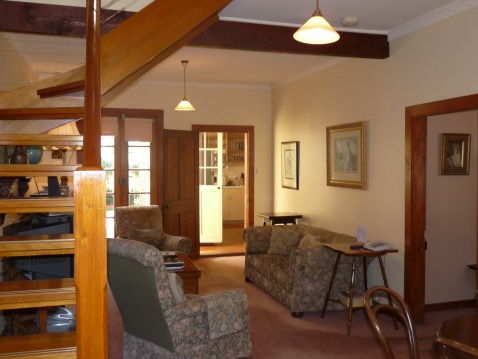Sussex Cottage lounge with stairway to loft bedroom